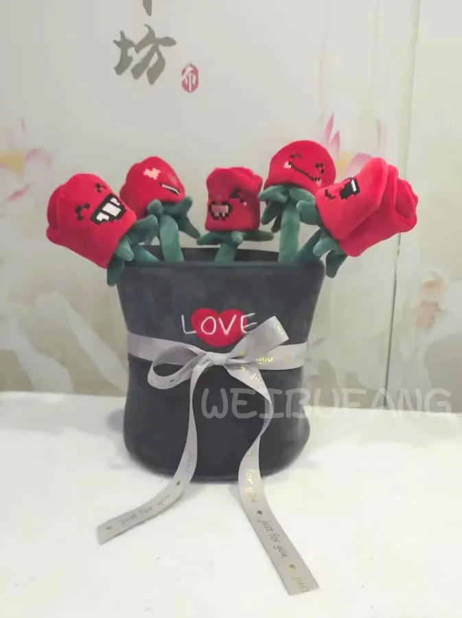 A bouquet of red character flowers in a dark fabric wrap.