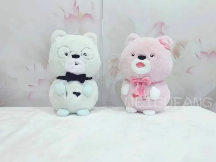 White and pink animal plush toys with coordinated bow details.