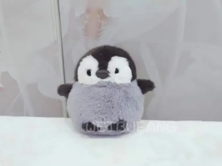 A small grey-and-white penguin with flipper-shaped wings.